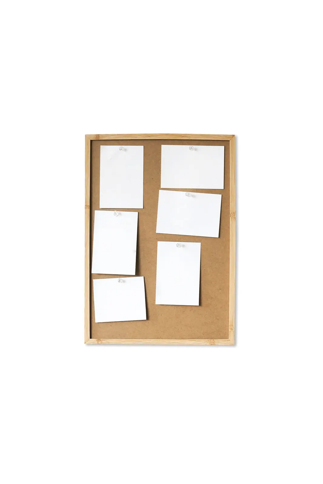 A cork board on a wall with blank notes pinned in loose rows.