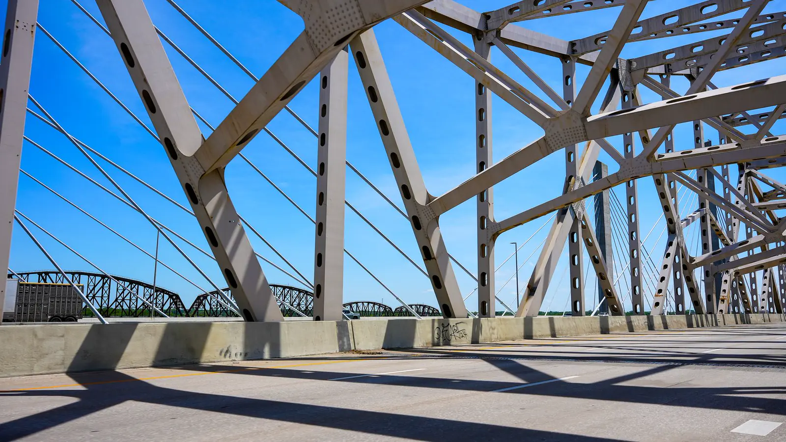 The steel underside of a bridge in Louisville, Kentucky, against a blue sky.